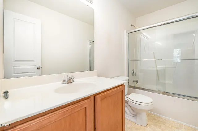 a bathroom with a sink a toilet and a window