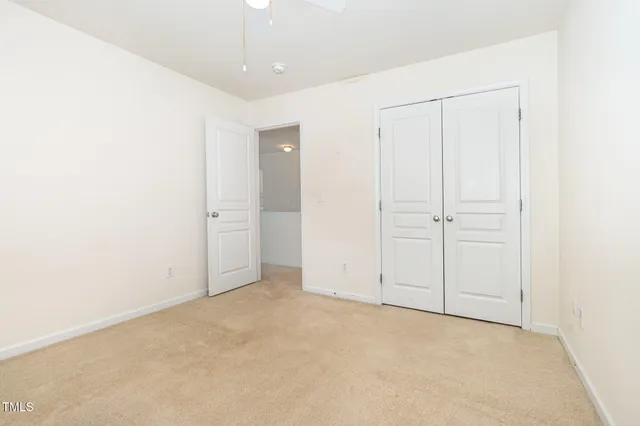 wooden floor in an empty room with a kitchen
