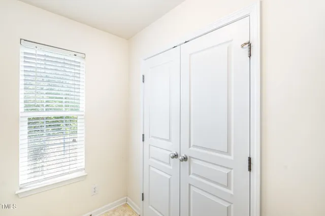 an empty room with a view of a house
