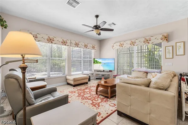 a living room with furniture and a large window