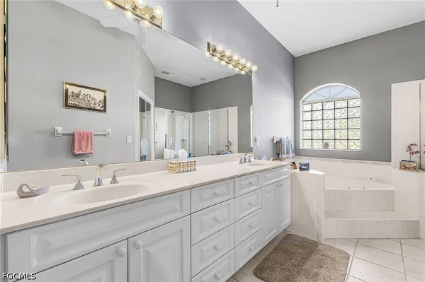 a spacious bathroom with sinks mirror and a bathtub