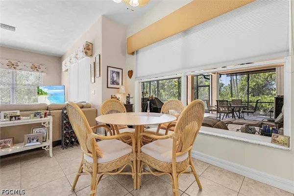 a dining room with furniture and a large window