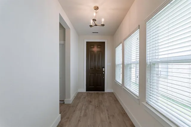 a view of a room with wooden floor and windows