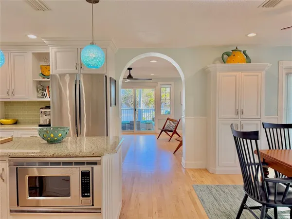 a living room with a baby crib furniture and a wooden floor