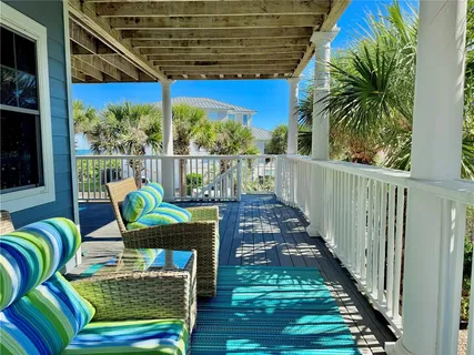 a bedroom with a bed couch and large window
