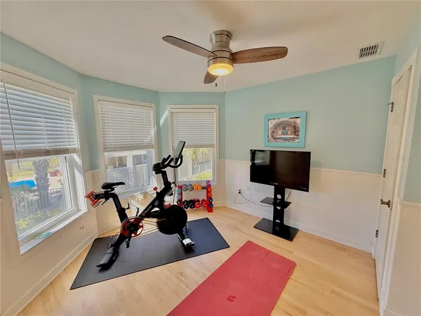 a living room with furniture and large windows