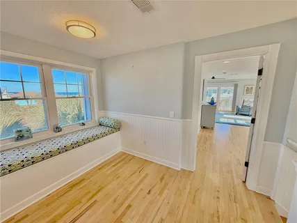 a bedroom with furniture and a flat screen tv