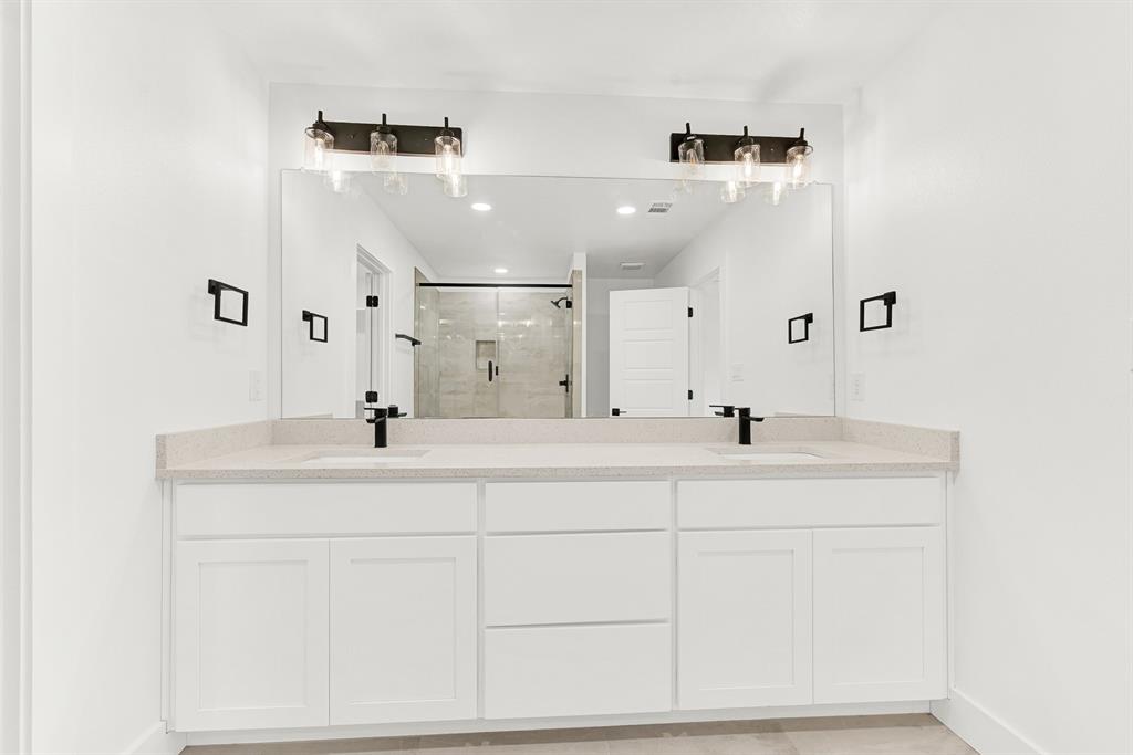 9471 Timberleaf Drive Dallas, TX 75243 - Photo 26 of 39 Double vanity featuring light-toned countertops and white cabinetry