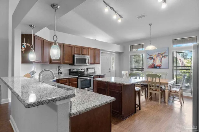 a kitchen with counter top space and stainless steel appliances