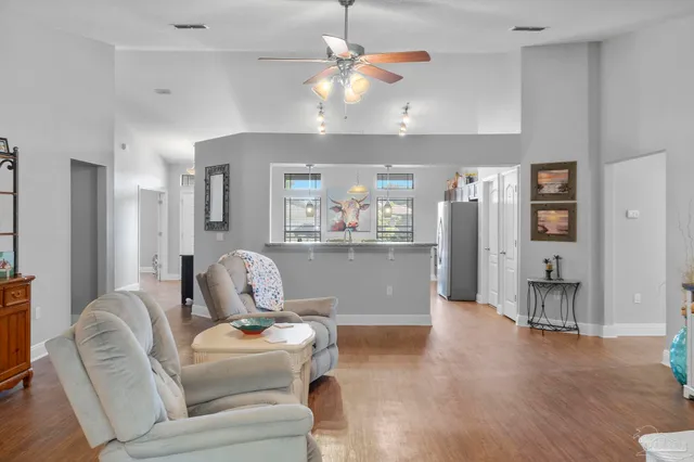 a living room with furniture and kitchen view