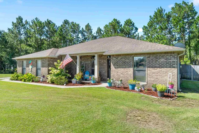 a front view of a house with a garden and porch
