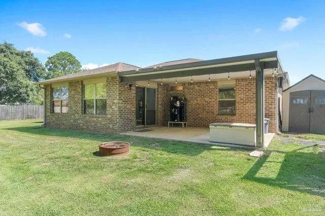 a view of a house with a garden and yard