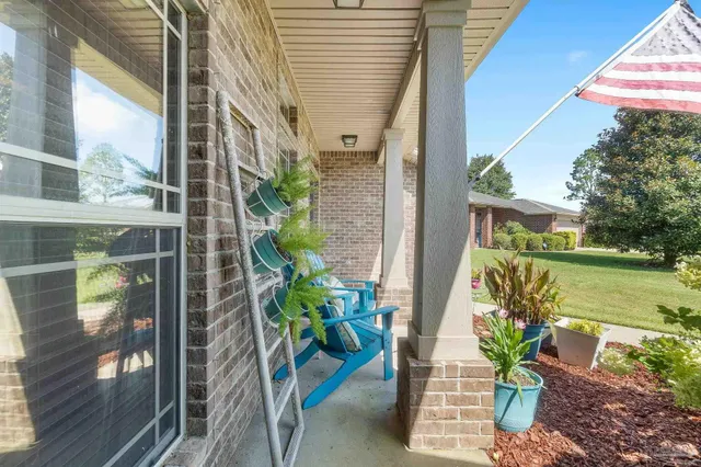 a view of a balcony with chair and table