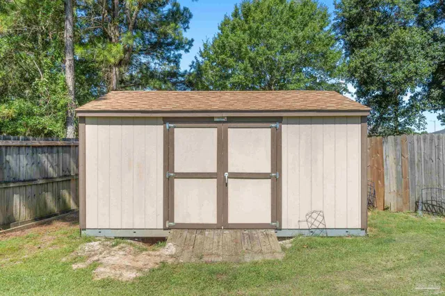 an aerial view of a house with swimming pool garden and patio