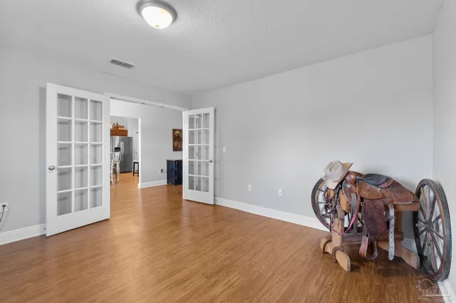 a kitchen with stainless steel appliances granite countertop a refrigerator a stove and a wooden floors