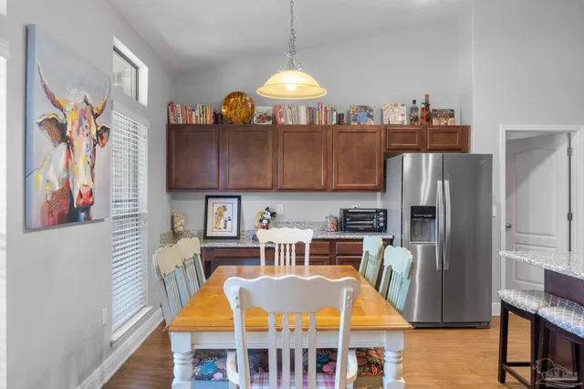 a view of a dining room with furniture wooden floor and a chandelier