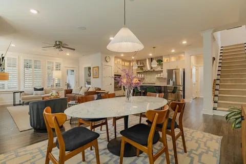 a view of a a dining room with furniture window and wooden floor