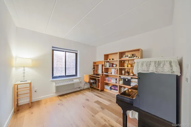 a view of a workspace with furniture and wooden floor