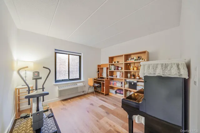 a bedroom with a bed and dresser with mirror