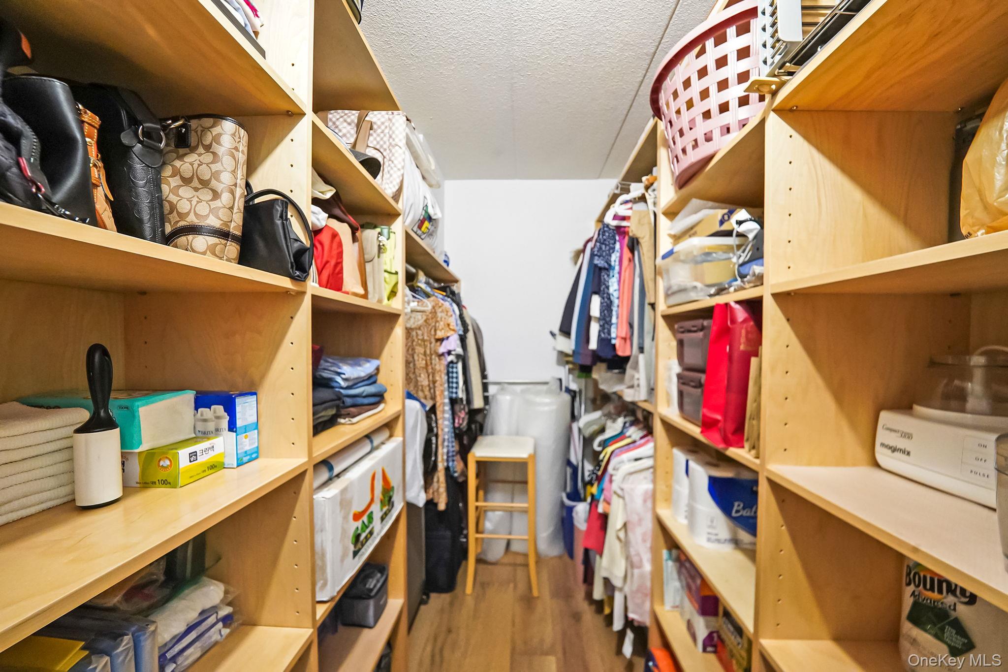 213-02 42nd Avenue, Unit 2A Queens, NY 11361 - Photo 18 of 24 a view of walk in closet with clothes and shoes