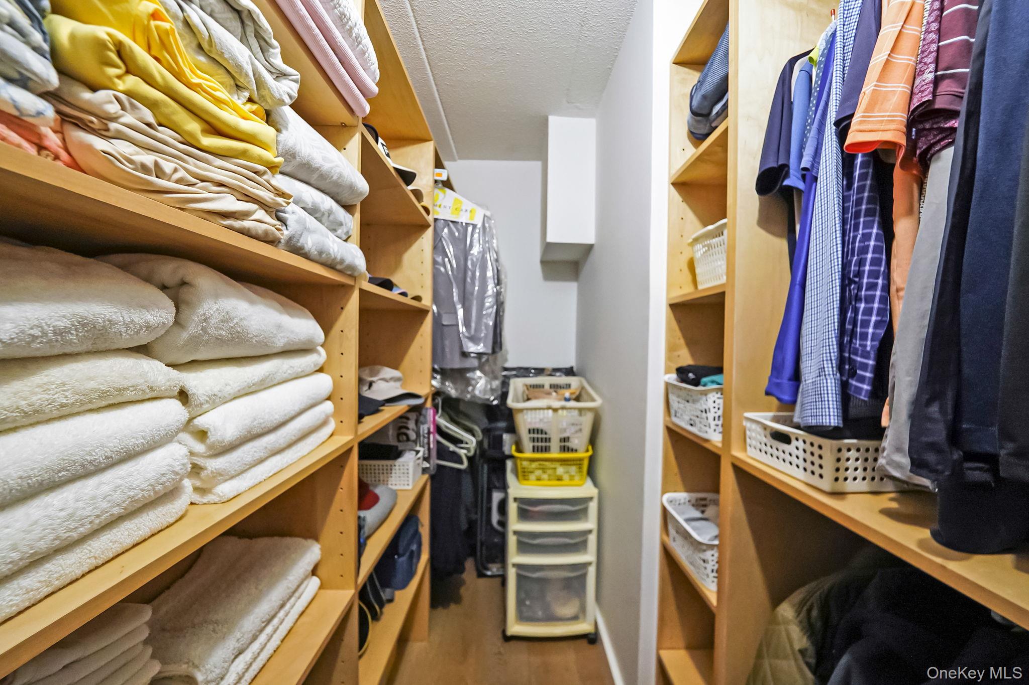 213-02 42nd Avenue, Unit 2A Queens, NY 11361 - Photo 19 of 24 a view of walk in closet with clothes and shoes