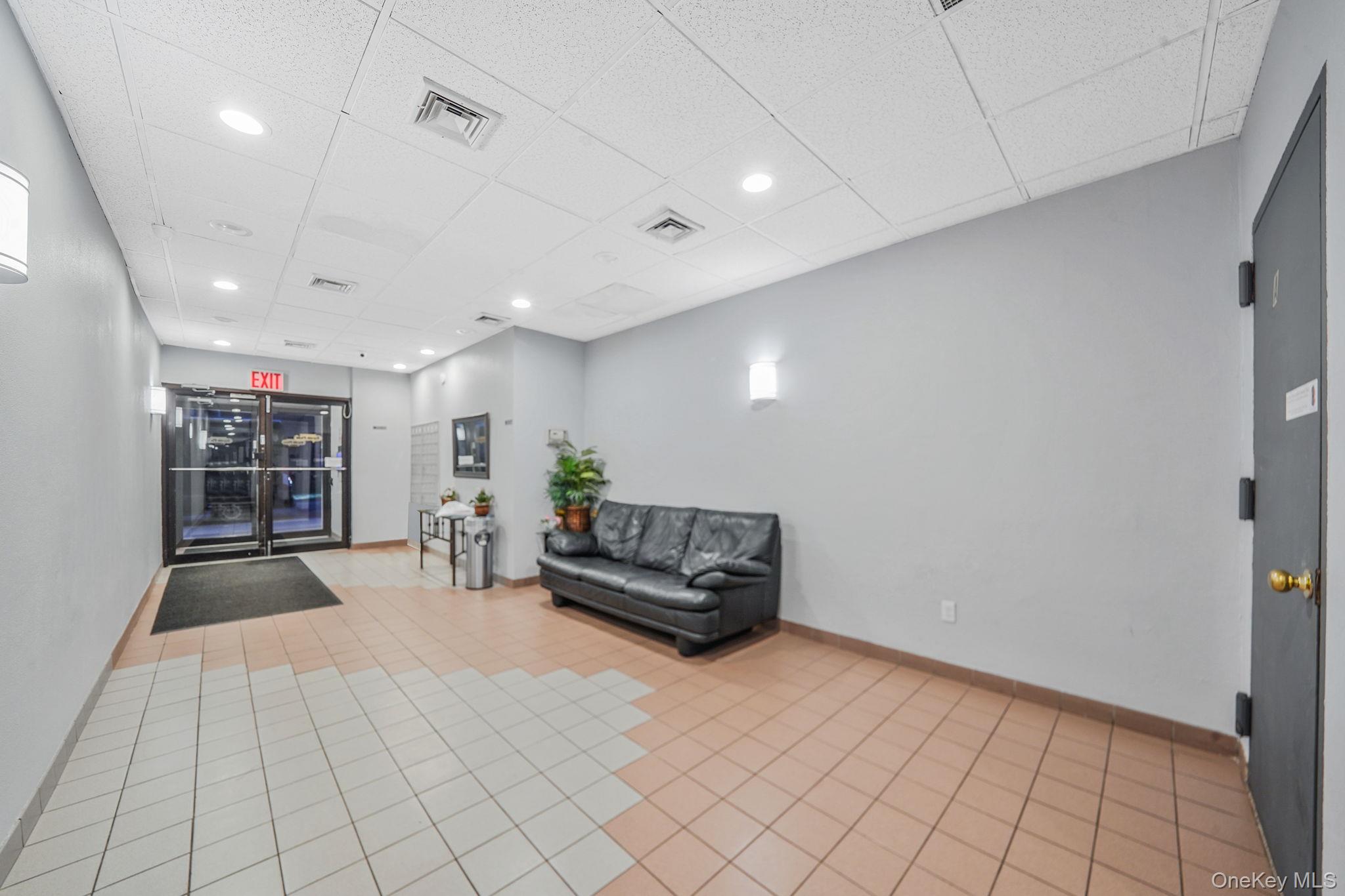 213-02 42nd Avenue, Unit 2A Queens, NY 11361 - Photo 5 of 24 a living room with furniture