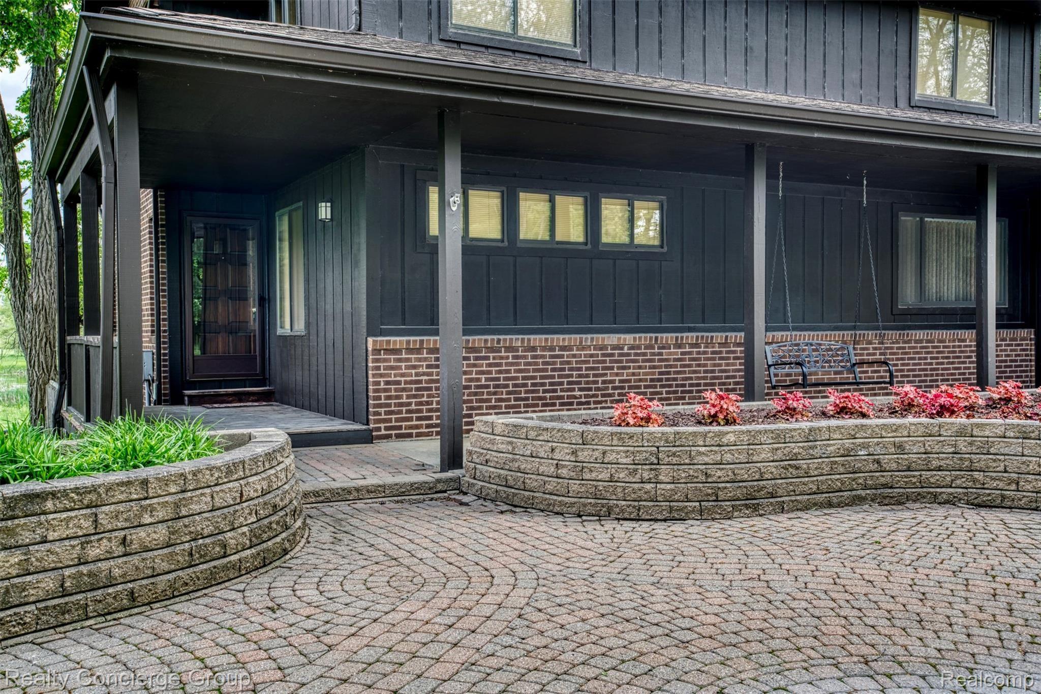 2110 East Clyde Road Howell, MI 48855 - Photo 22 of 44 Gorgeous pavers and custom garden beds add character to the front of this 1 1/2 story contemporary wood & brick home