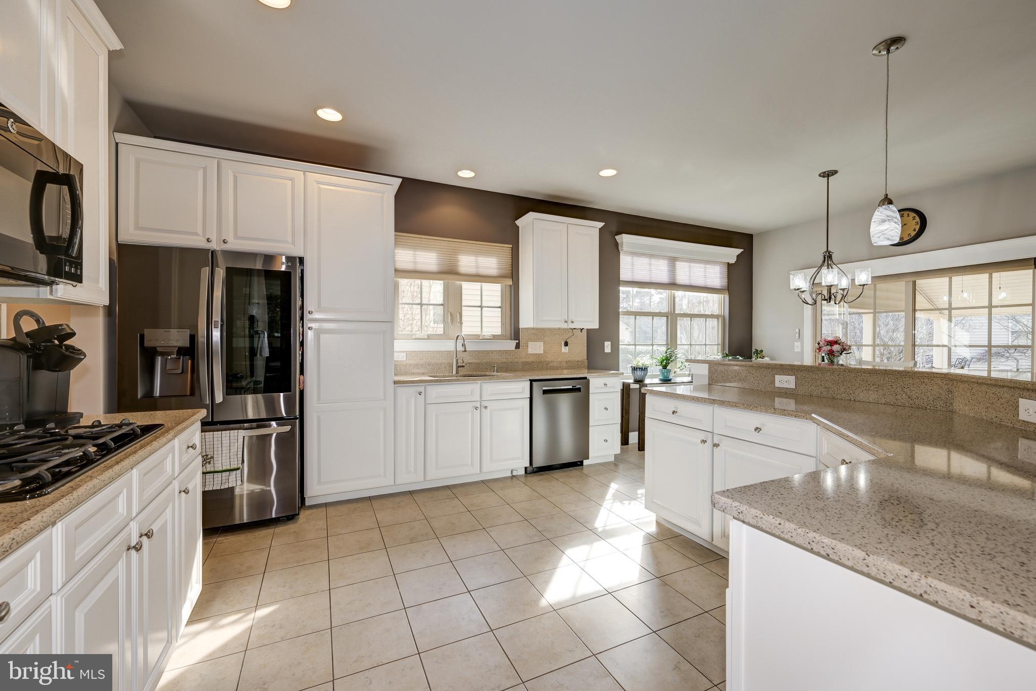 18 Genova Drive West Berlin, NJ 08091 - Photo 14 of 49 a kitchen with stainless steel appliances granite countertop a stove a sink and a refrigerator