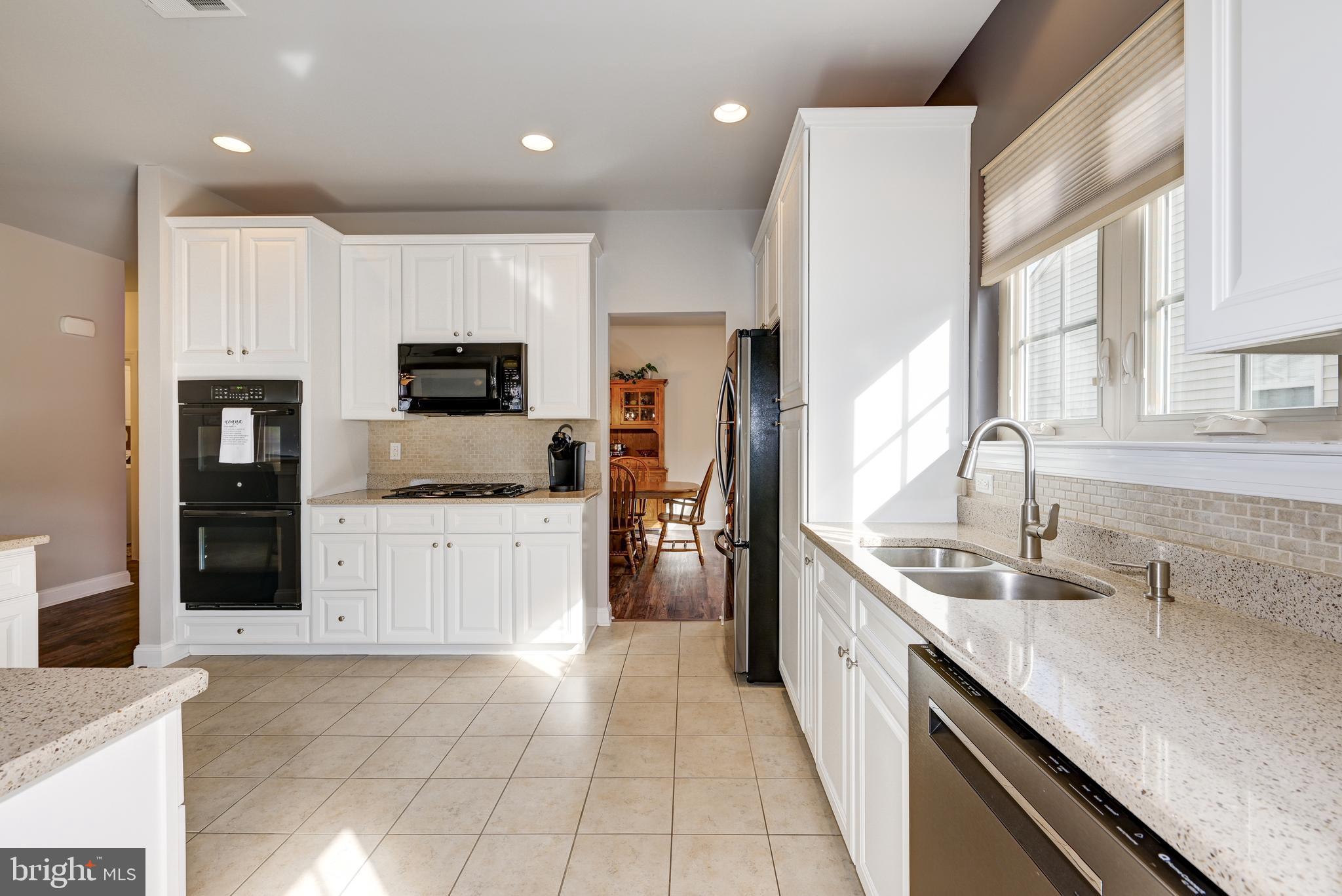 18 Genova Drive West Berlin, NJ 08091 - Photo 18 of 49 a large kitchen with stainless steel appliances granite countertop a large counter top a stove a sink and a refrigerator