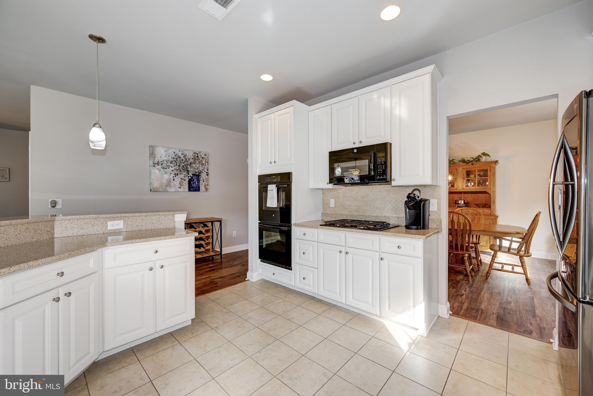 18 Genova Drive West Berlin, NJ 08091 - Photo 19 of 49 a kitchen with white cabinets and appliances