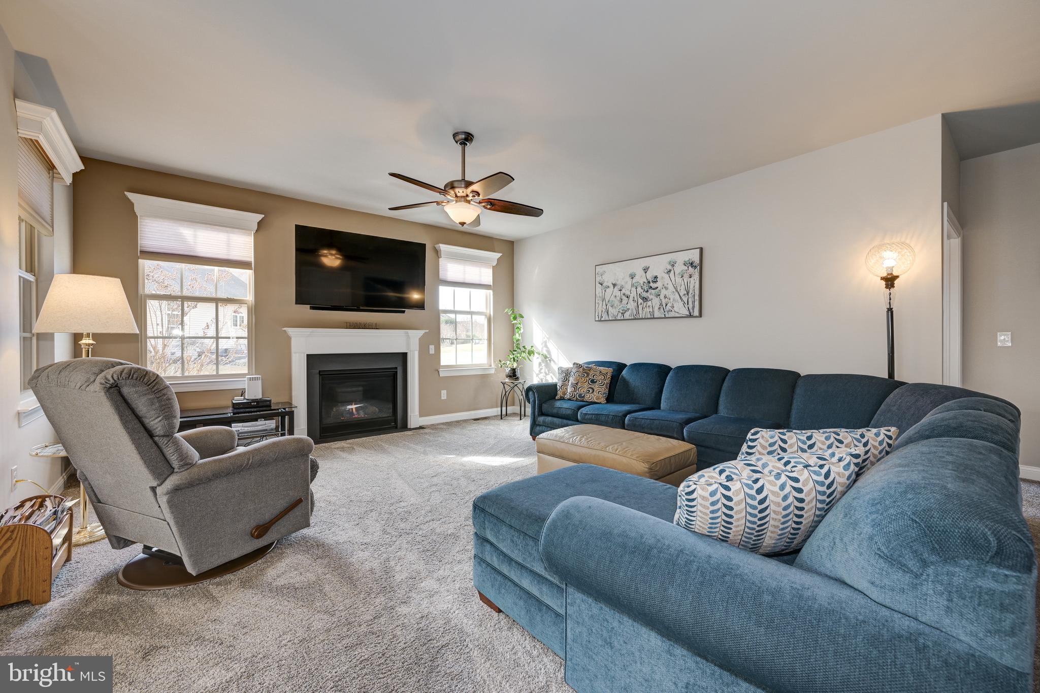 18 Genova Drive West Berlin, NJ 08091 - Photo 24 of 49 a living room with furniture a flat screen tv and a fireplace