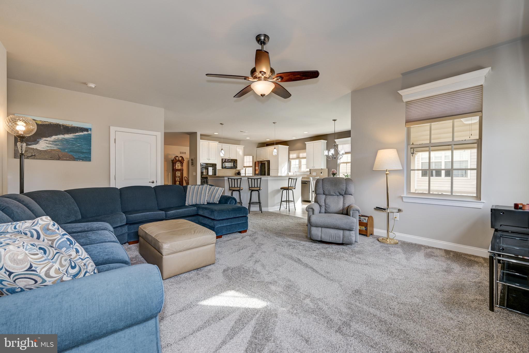 18 Genova Drive West Berlin, NJ 08091 - Photo 27 of 49 a living room with furniture and a chandelier