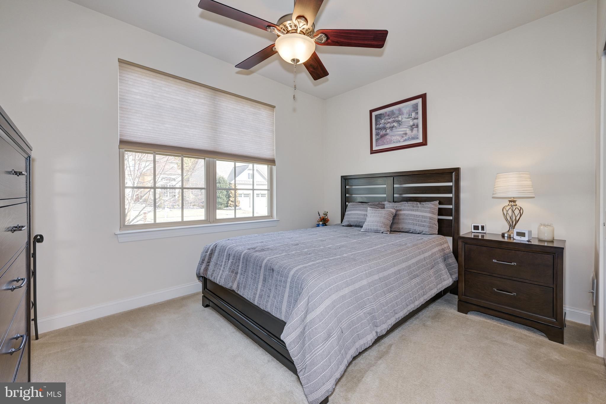 18 Genova Drive West Berlin, NJ 08091 - Photo 32 of 49 a bedroom with a bed and a chandelier