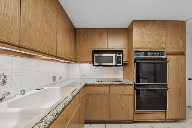 a kitchen with granite countertop stainless steel appliances and cabinets