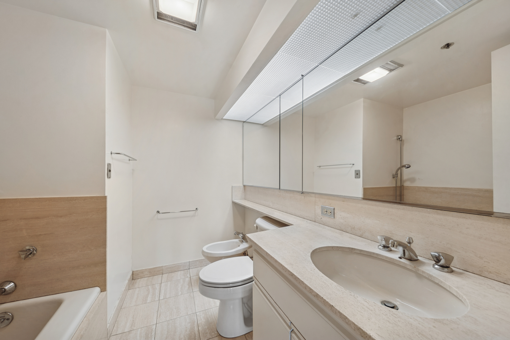 950 North Michigan Avenue, Unit 3104 Chicago, IL 60611 - Photo 19 of 28 a bathroom with a sink a toilet and shower