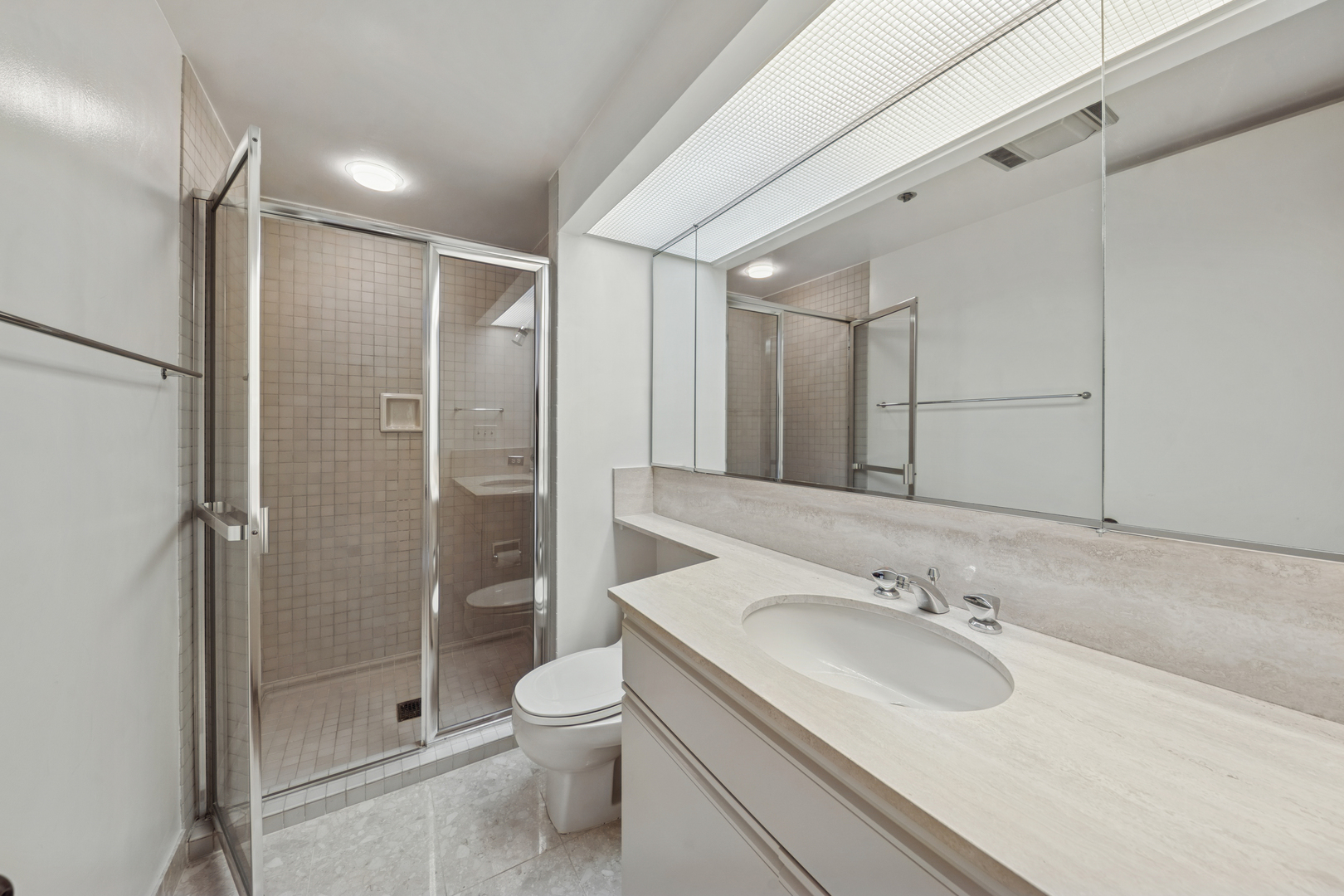 950 North Michigan Avenue, Unit 3104 Chicago, IL 60611 - Photo 23 of 28 a bathroom with a sink toilet and shower