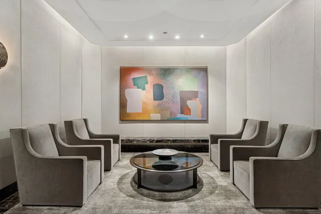 a living room with furniture a couch and a potted plant