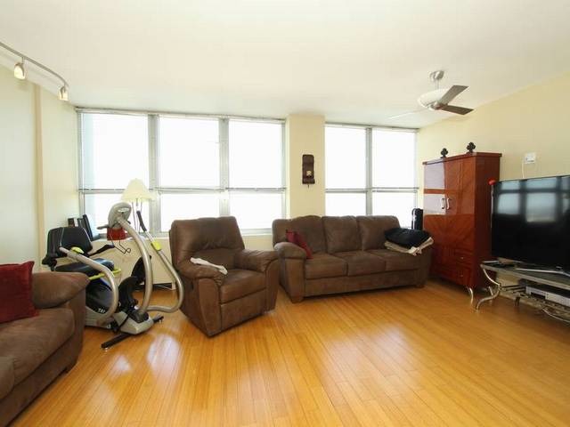 655 West Irving Park Road, Unit 4014 Chicago, IL 60613 - Photo 3 of 16 a living room with furniture a flat screen tv and a window