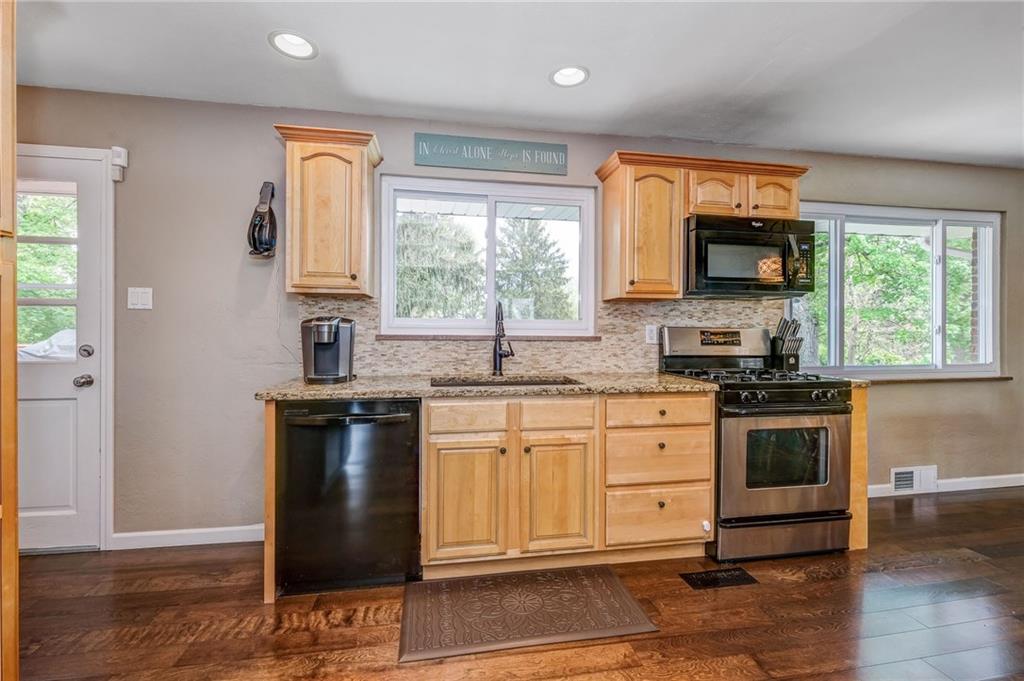 The stunning kitchen has newer appliances and granite counter tops!