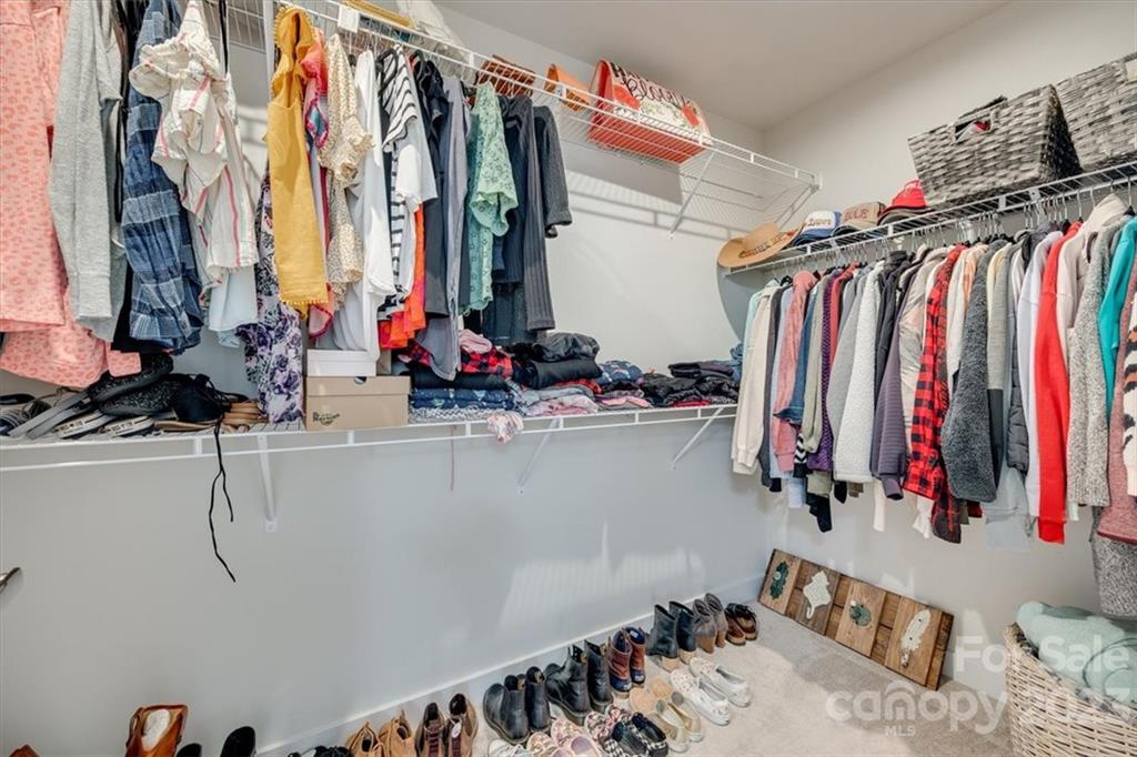 7102 Messina Road Indian Land, SC 29707 - Photo 23 of 38 a view of walk in closet with clothes and shoes