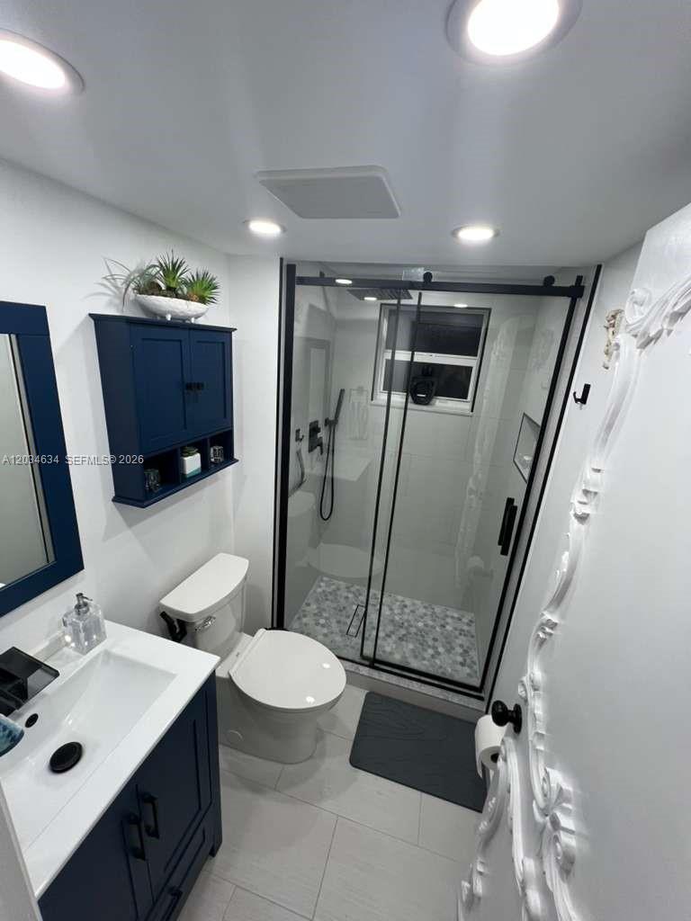 9880 Marina Boulevard, Unit 1516 Boca Raton, FL 33428 - Photo 21 of 32 a bathroom with a sink mirror vanity and toilet