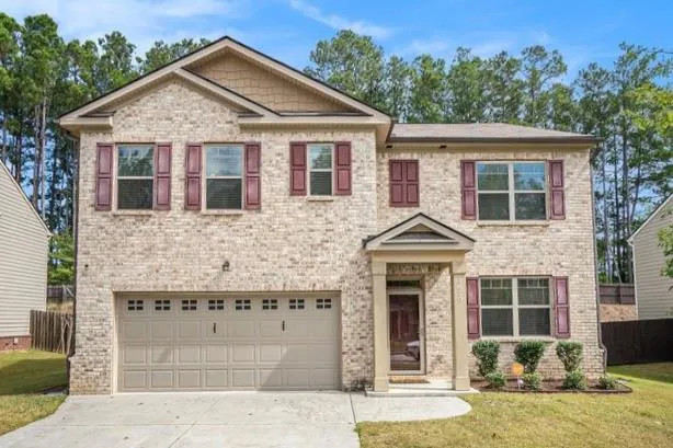 a front view of a house with a yard