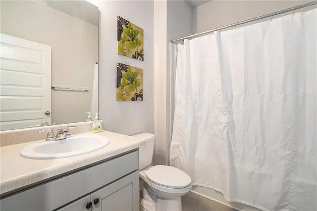 a bathroom with a sink toilet and a mirror