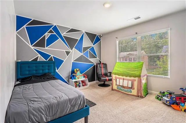 a bedroom that has a bed and a chair