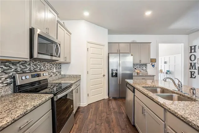 a kitchen with a sink stove and refrigerator