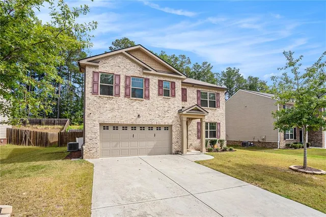a front view of a house with a yard