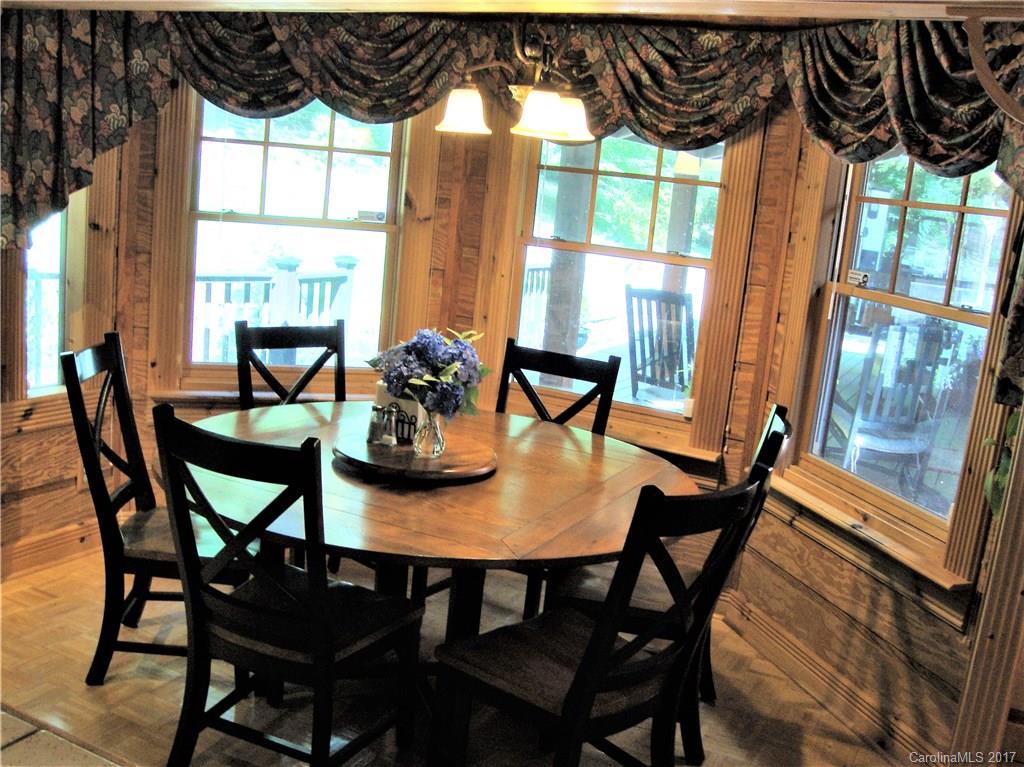 720 Potneck Road, Unit 1517 Salisbury, NC 28147 - Photo 11 of 24 a dining room with furniture a chandelier and wooden floor