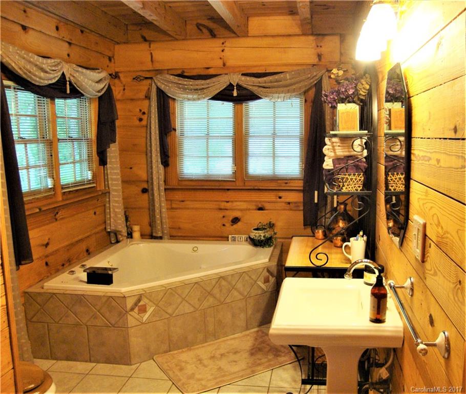 720 Potneck Road, Unit 1517 Salisbury, NC 28147 - Photo 20 of 24 a bath tub sitting next to a blue and white sink