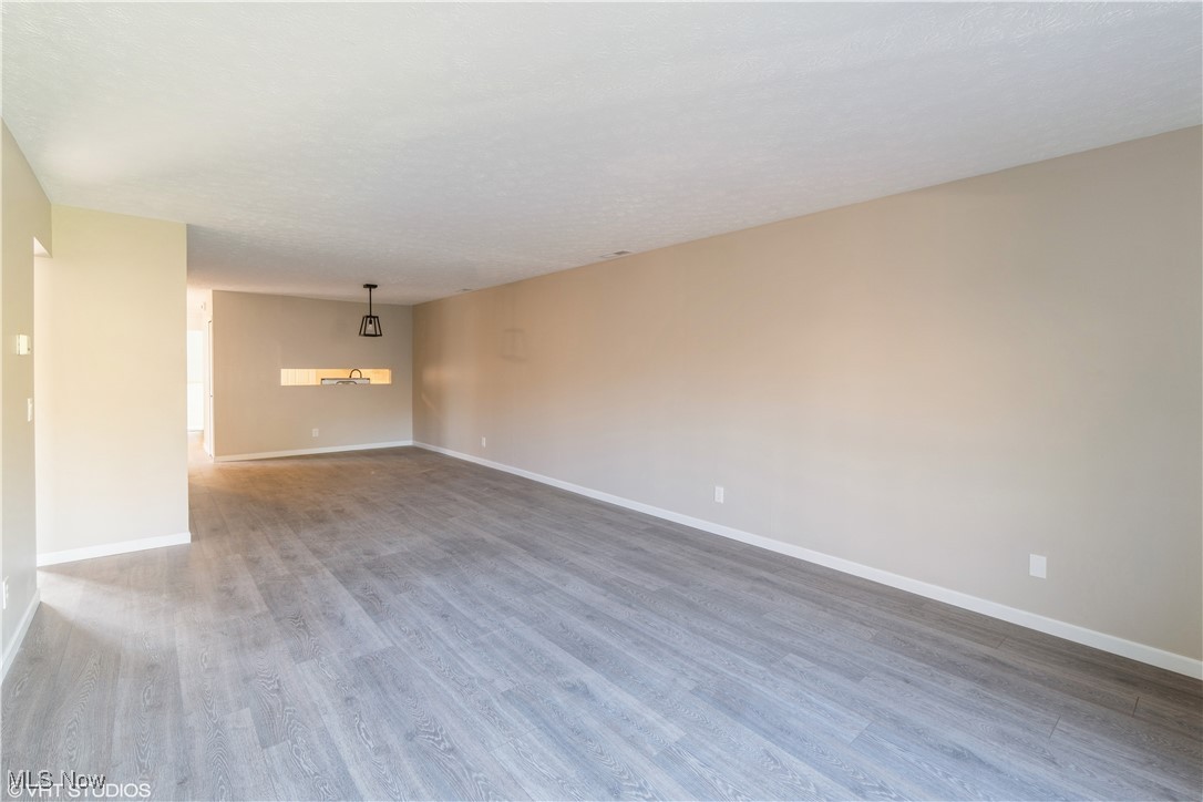 3725 Mayfield Road Cleveland Heights, OH 44121 - Photo 6 of 16 Spare room with a textured ceiling and hardwood / wood-style flooring