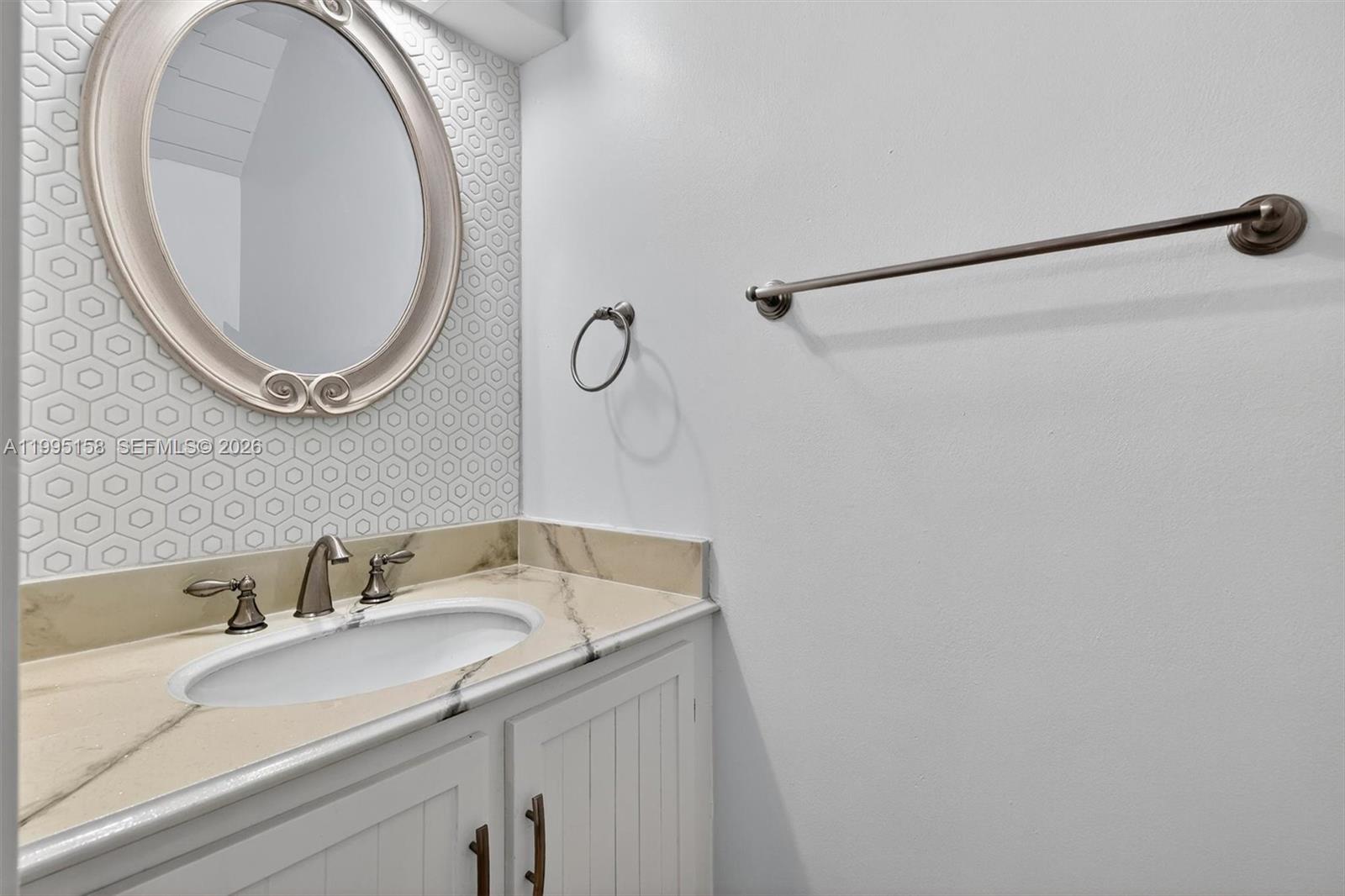 6161 Southwest 90th Court, Unit G2 Miami, FL 33173 - Photo 18 of 47 a bathroom with a sink and a mirror